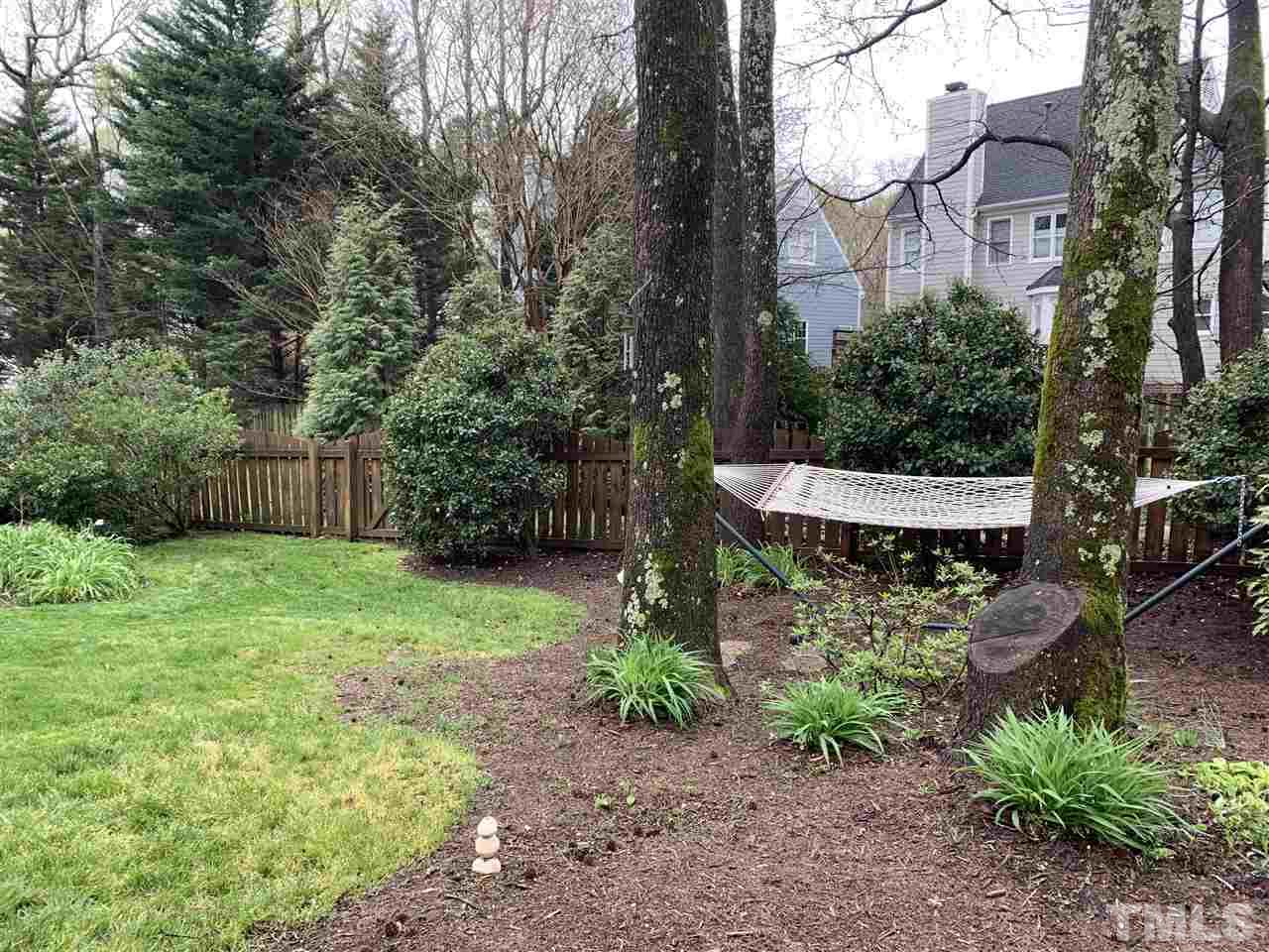 9105 Cub Trail Raleigh, NC 27615 - Photo 21 of 22 a view of a backyard with plants and large trees