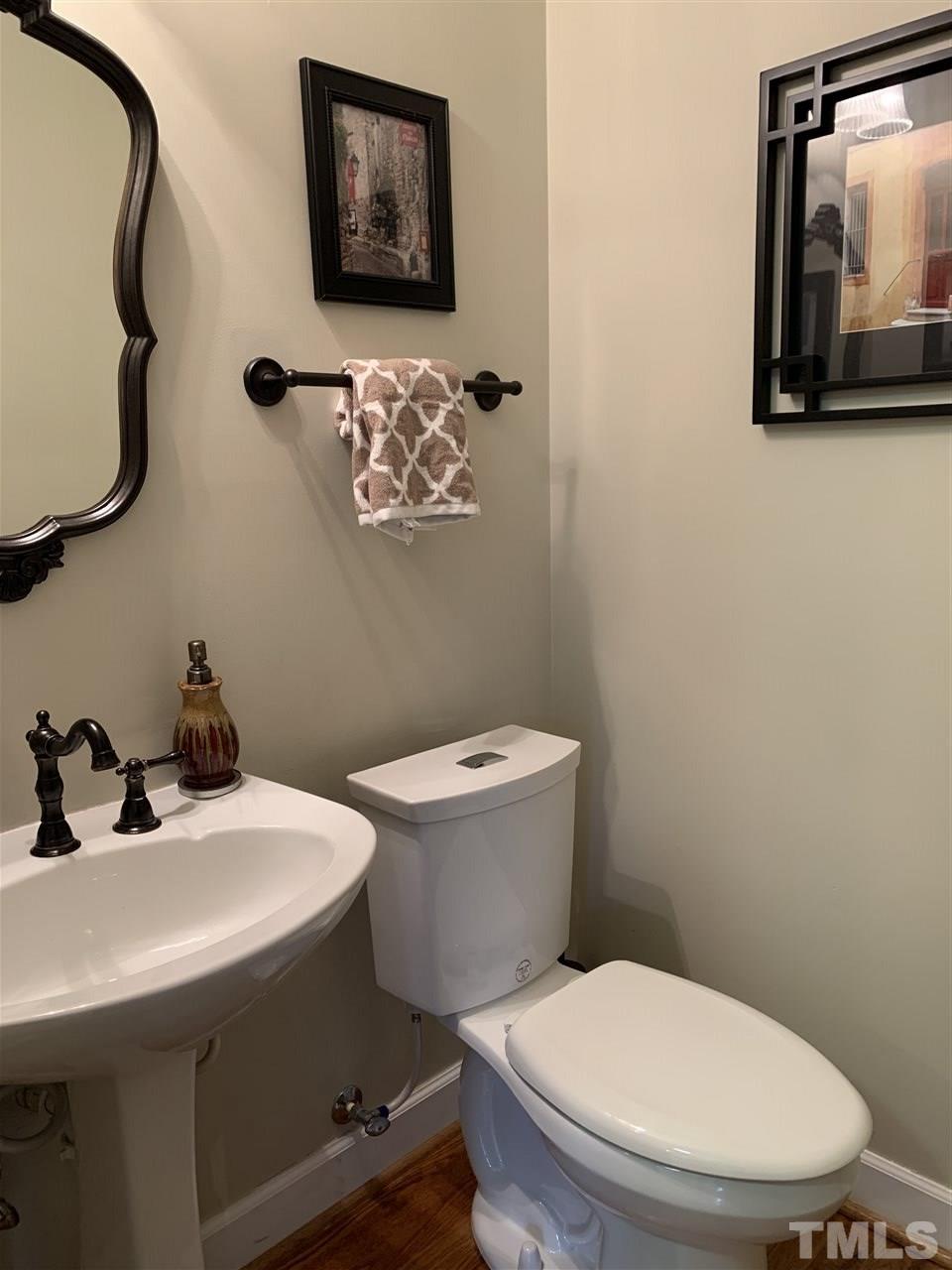 9105 Cub Trail Raleigh, NC 27615 - Photo 9 of 22 a bathroom with a toilet a sink and mirror