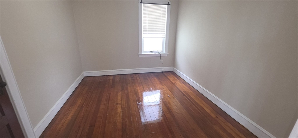 105 6th Street, Unit 3 Fall River, MA 02721 - Photo 9 of 10 a view of empty room with wooden floor and fan