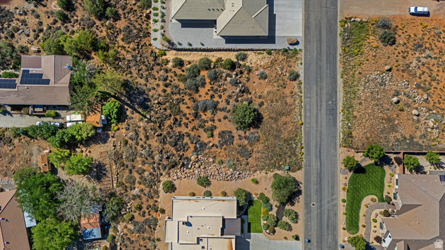 240 Boulder Way, Unit 3 Leeds, UT 84746 - Photo 9 of 12 Expansive land parcel featuring natural desert flora, bordering a paved street
