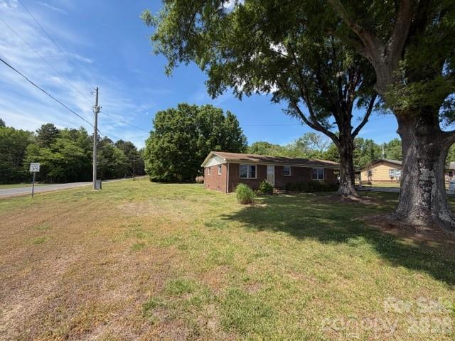 20415 Efird Road Albemarle, NC 28001 - Photo 15 of 16 a view of a yard in front of a house with large trees