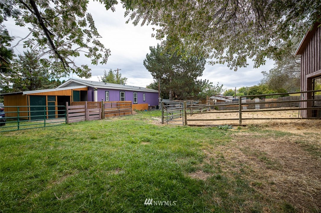 373 Conconully Road Okanogan, WA 98840 - Photo 17 of 24 a view of a house with backyard and a tree