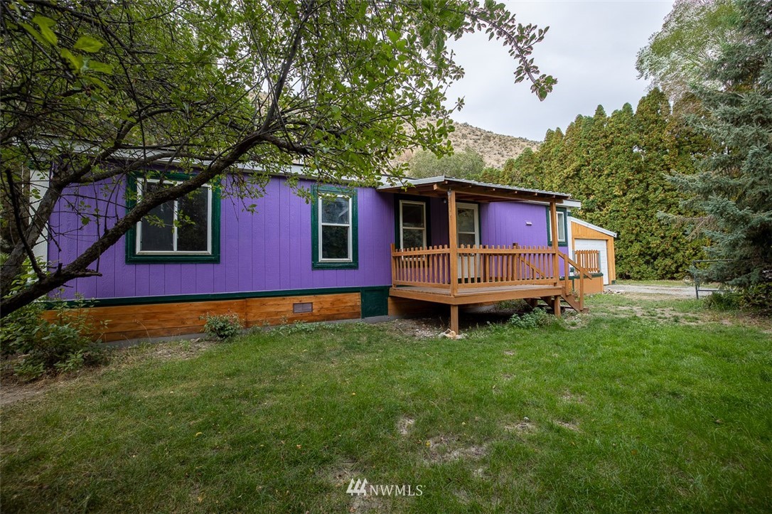 373 Conconully Road Okanogan, WA 98840 - Photo 3 of 24 a view of a house with a backyard