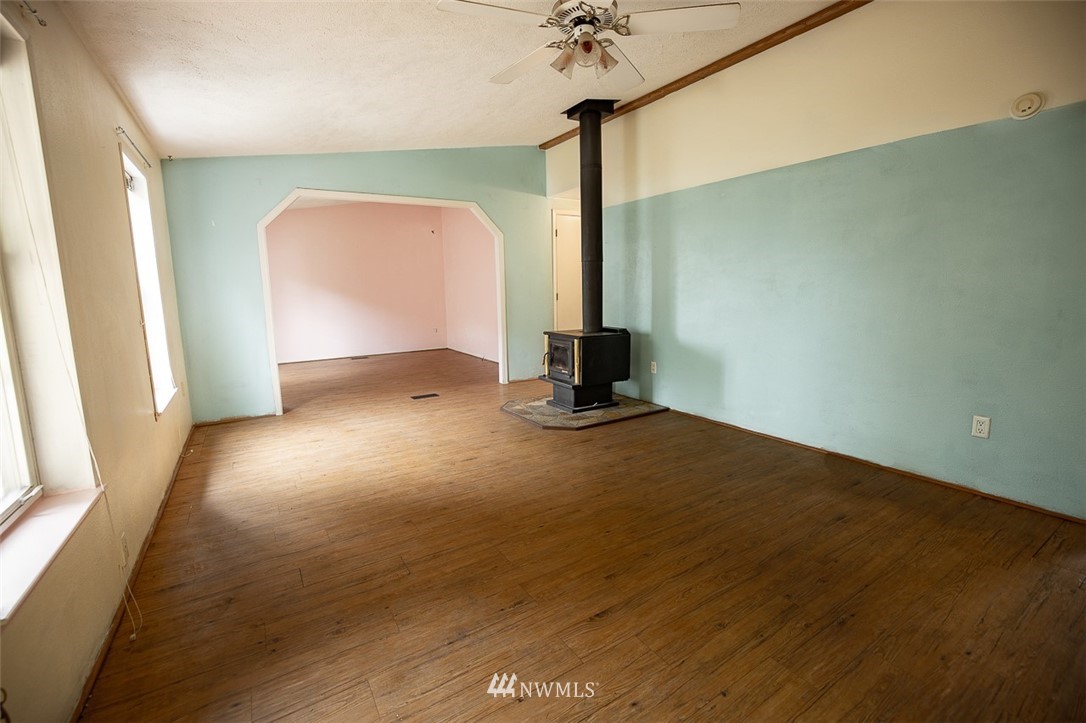 373 Conconully Road Okanogan, WA 98840 - Photo 7 of 24 an empty room with wooden floor and windows