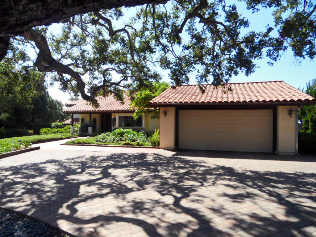 238 Las Alturas Road Santa Barbara, CA 93103 - Photo 1 of 20 a front view of a house with a yard and garage