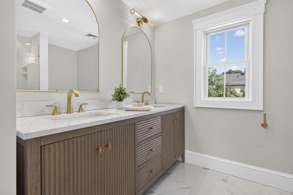 20 Saltonstall Road Medford, MA 02155 - Photo 26 of 41 a bathroom with a double vanity sink and a mirror
