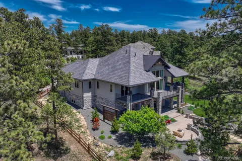 an aerial view of a house with garden space and street view