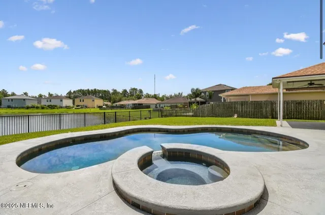 a view of swimming pool with seating space and yard
