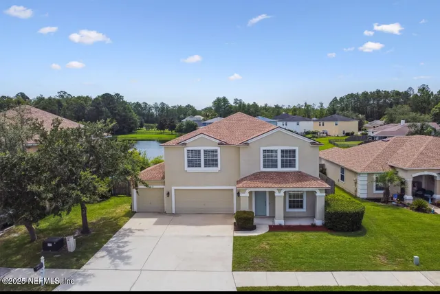 a front view of house with yard and green space