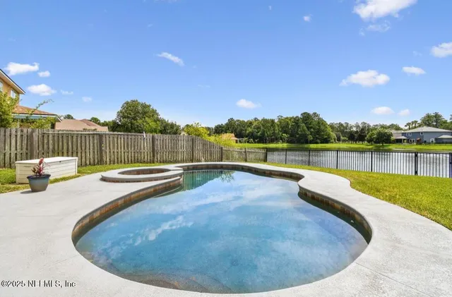 a view of swimming pool with lake and mountain in the back