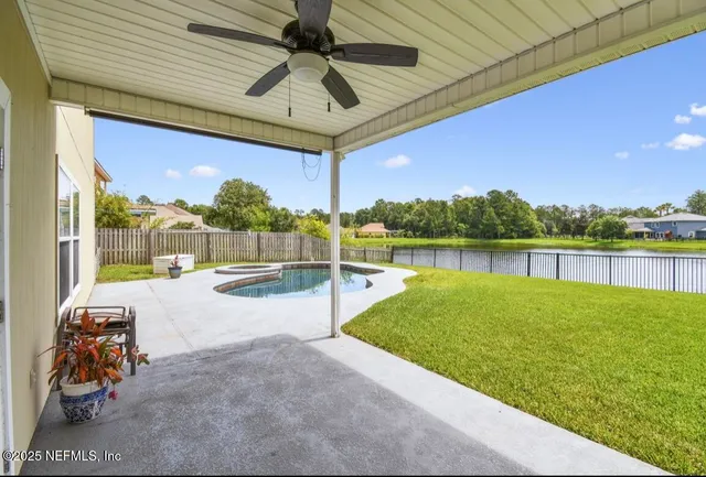 a view of swimming pool with outdoor seating and yard