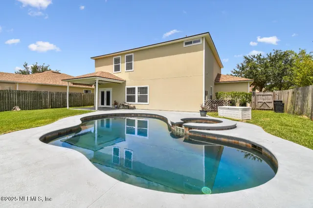 a view of house with swimming pool outdoor seating
