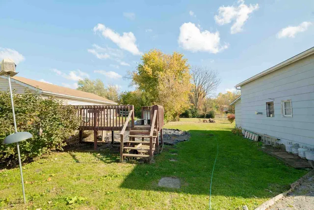 a view of a house with backyard and sitting area