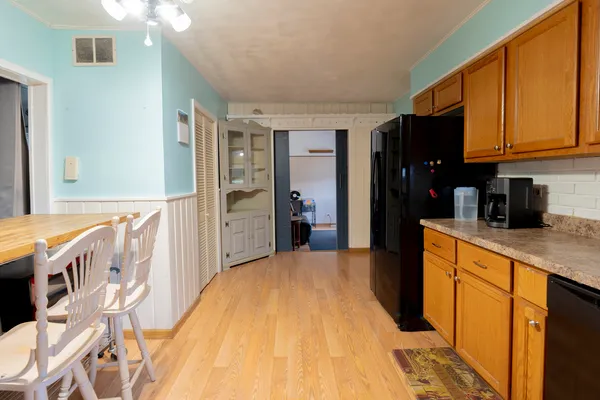 a kitchen with stainless steel appliances granite countertop a refrigerator and a stove top oven