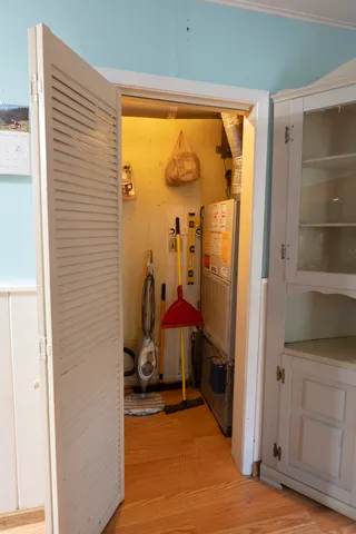 a view of a room with wooden floor and furniture