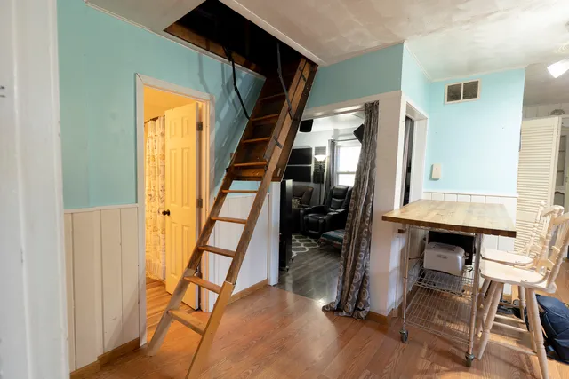 a view of entryway with workspace and wooden floor