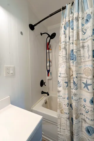 a bathroom with a bathtub and shower