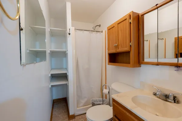 a bathroom with a sink toilet and shower