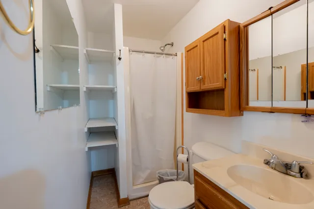 a bathroom with a sink toilet and shower