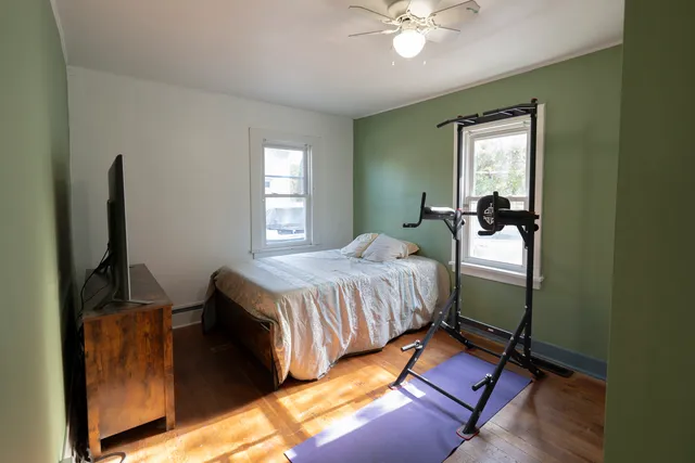 a bedroom with a bed and a mirror