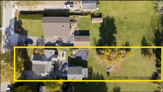 an aerial view of a house with a yard
