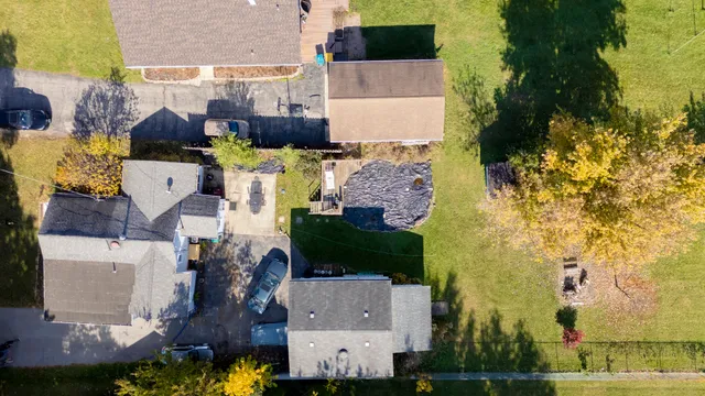 an aerial view of residential houses with outdoor space and parking