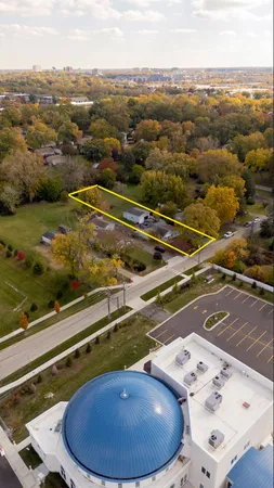 an aerial view of a house with a big yard