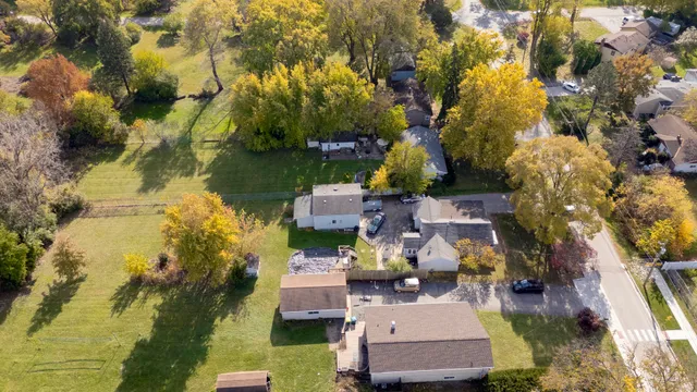a aerial view of a house with a yard basket ball court and outdoor seating