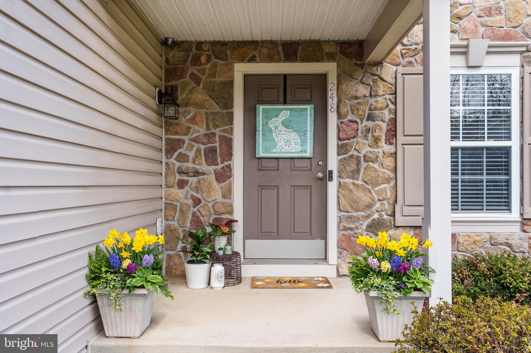 248 Patriots Way Elkton, MD 21921 - Photo 2 of 40 a vase of flowers sitting in front of a door