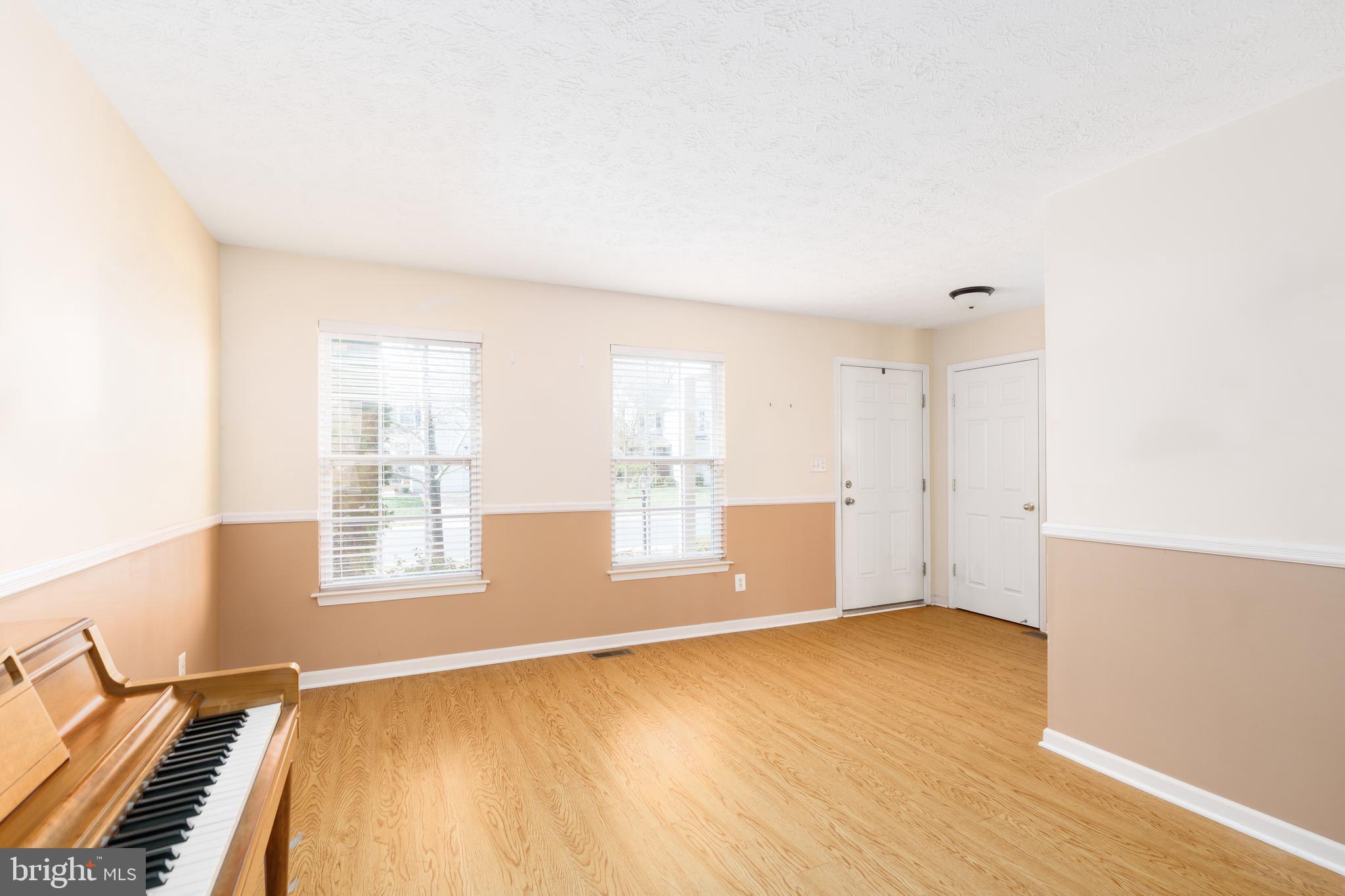 248 Patriots Way Elkton, MD 21921 - Photo 4 of 40 a view of an empty room with wooden floor and a window