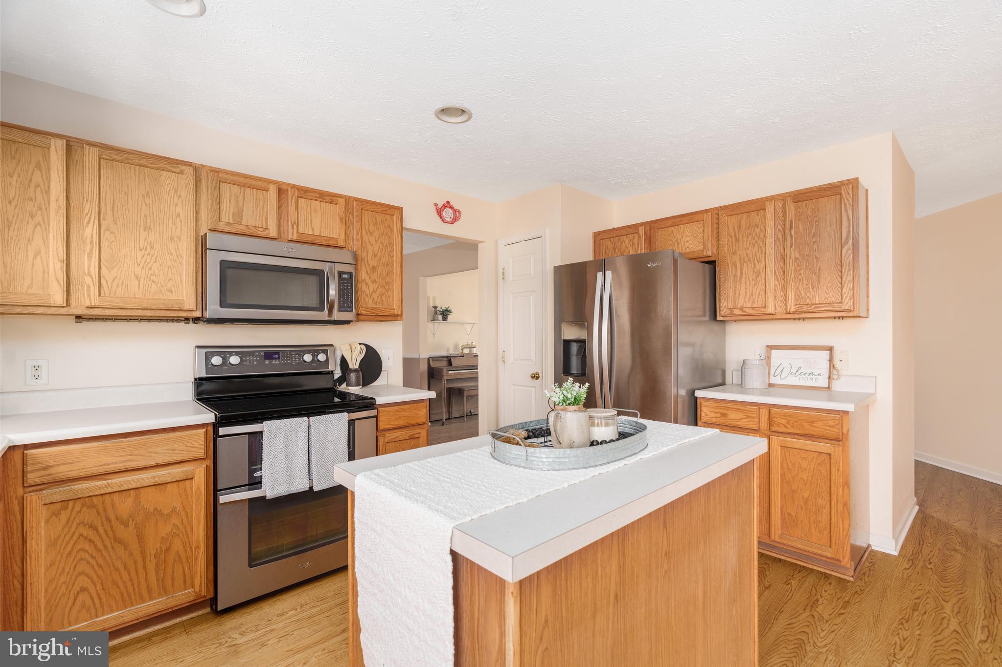 248 Patriots Way Elkton, MD 21921 - Photo 7 of 40 a kitchen with stainless steel appliances a stove top oven a sink refrigerator and a microwave