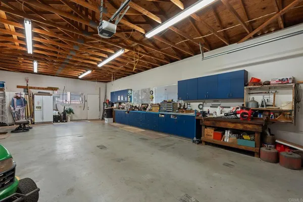 a utility room with stainless steel appliances granite countertop a stove a washer and dryer