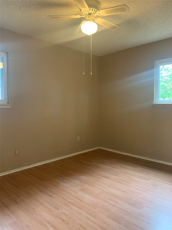 11701 Bayou Bend, Unit B Austin, TX 78759 - Photo 12 of 17 a view of a room with wooden floor and fan