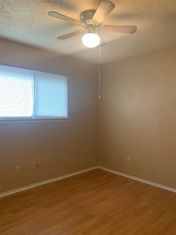 11701 Bayou Bend, Unit B Austin, TX 78759 - Photo 13 of 17 an empty room with a window and a fan