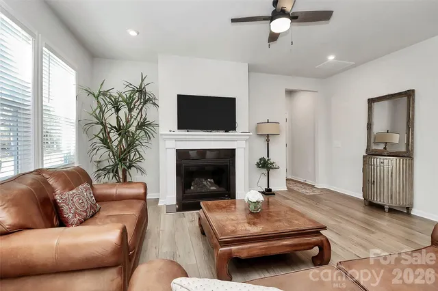 a living room with furniture fireplace and window