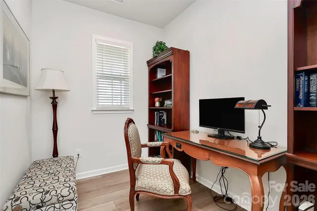 a view of a workspace with furniture and a window
