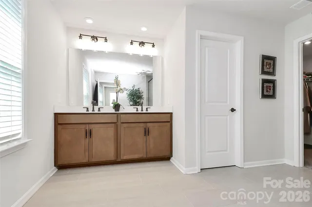 a bathroom with a sink vanity and mirror