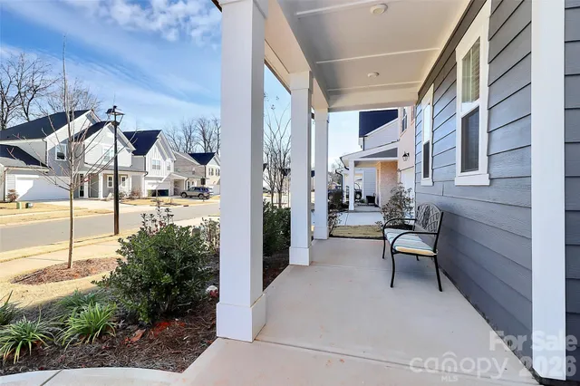 a view of a patio with table and chairs and potted plants