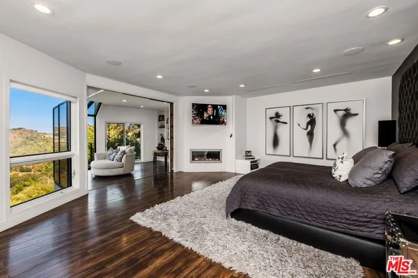 a bedroom with a large bed and a large window