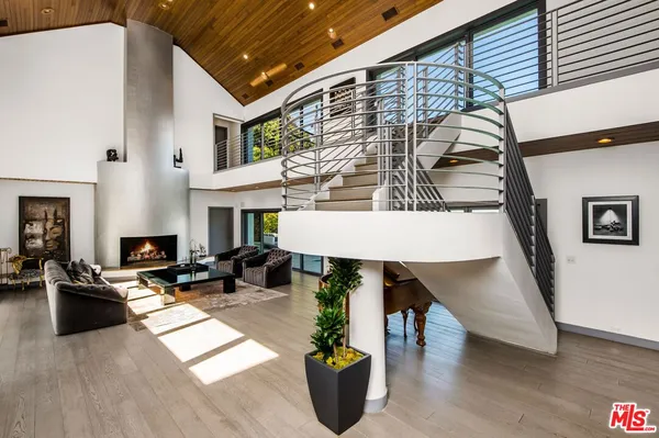 a living room with furniture wooden floor and a fireplace
