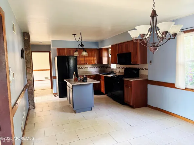 a kitchen with stainless steel appliances granite countertop a stove top oven a refrigerator a sink and dishwasher