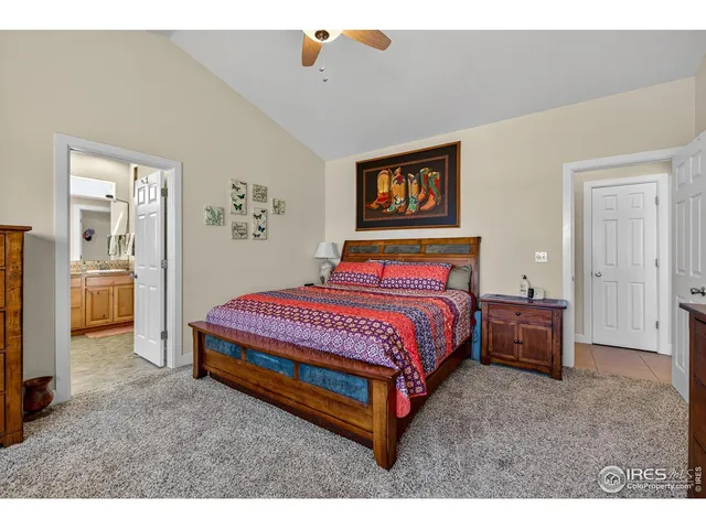 a bedroom with a bed and a view of kitchen