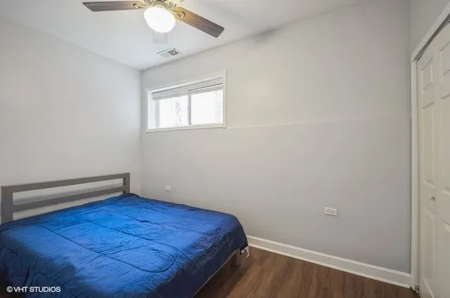 a view of a room with wooden floor and fan