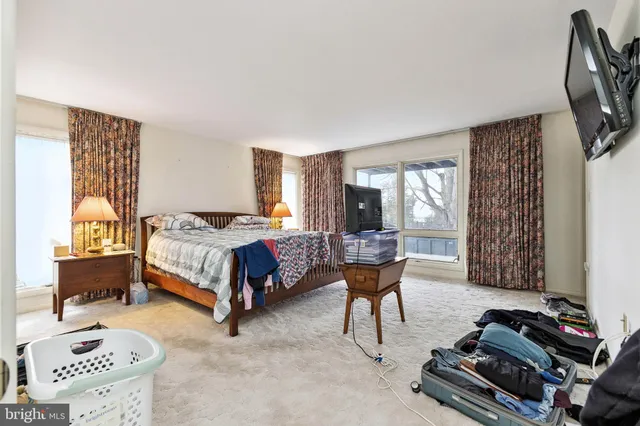 a bed room with a bed and a television