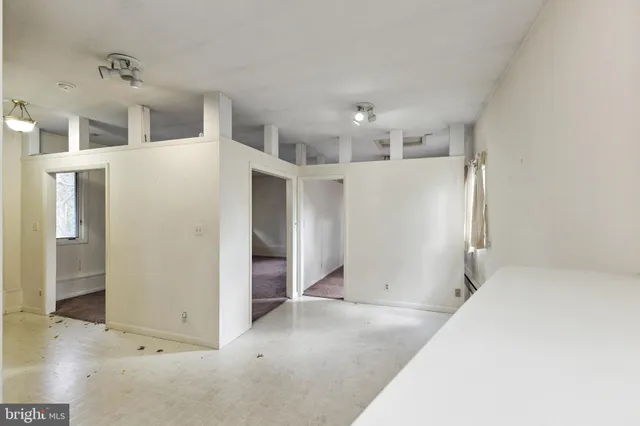 a view of a bedroom with window and furniture
