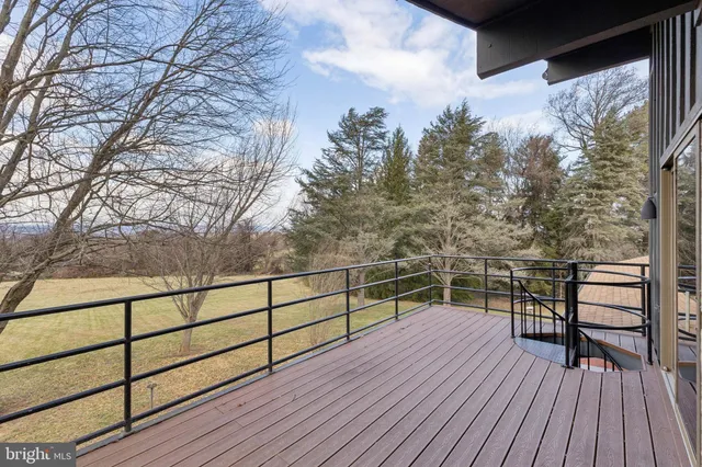 a view of a roof deck with wooden floor and fence