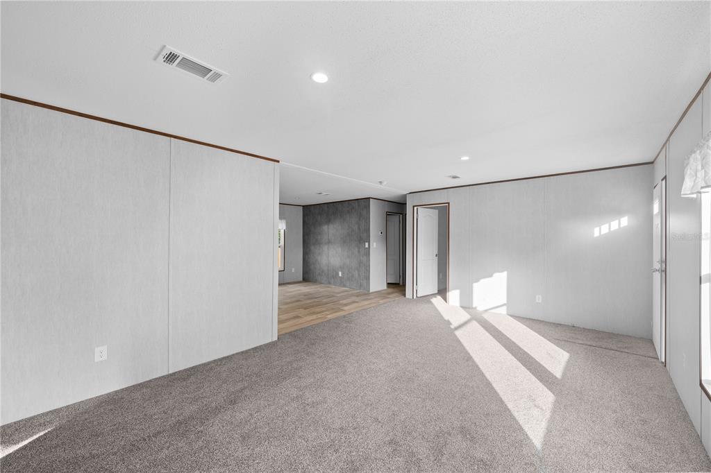 9160 Southwest 31st Avenue Road Ocala, FL 34476 - Photo 13 of 30 a view of a big room with a chandelier fan and a bathroom