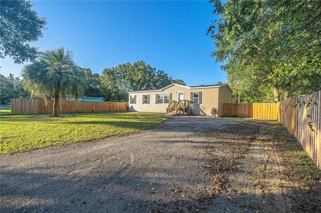 9160 Southwest 31st Avenue Road Ocala, FL 34476 - Photo 3 of 30 a view of a house with a yard