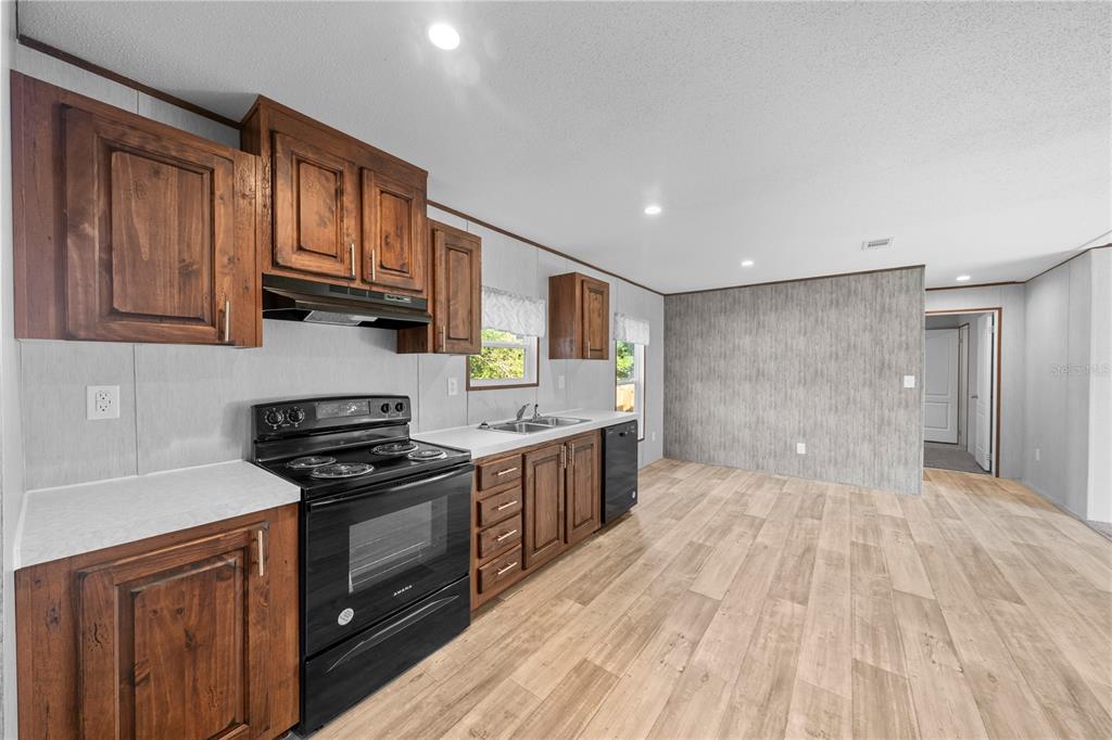 9160 Southwest 31st Avenue Road Ocala, FL 34476 - Photo 7 of 30 a kitchen with stainless steel appliances granite countertop a stove a sink and a refrigerator