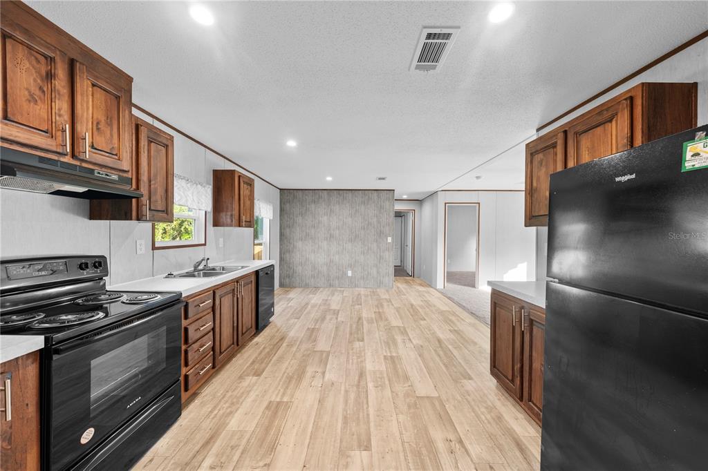 9160 Southwest 31st Avenue Road Ocala, FL 34476 - Photo 9 of 30 a kitchen with stainless steel appliances granite countertop a stove and a refrigerator